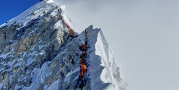 Mount Everest – Climbers queue to reach the 8,849-meter summit
