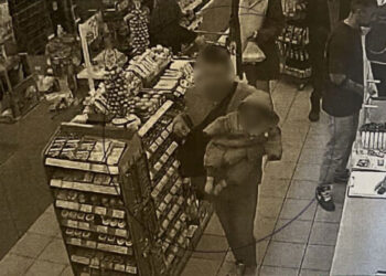 Photographic evidence of man holding 6-month-old baby in a supermarket in Alimos