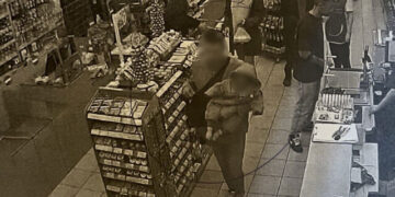 Photographic evidence of man holding 6-month-old baby in a supermarket in Alimos